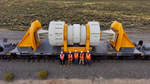 Workers pose with a new train car designed to carry highly-radioactive nuclear waste from power plants around the country. An economic development group in northwest Colorado is entertaining the idea of pursuing a storage facility for the waste.