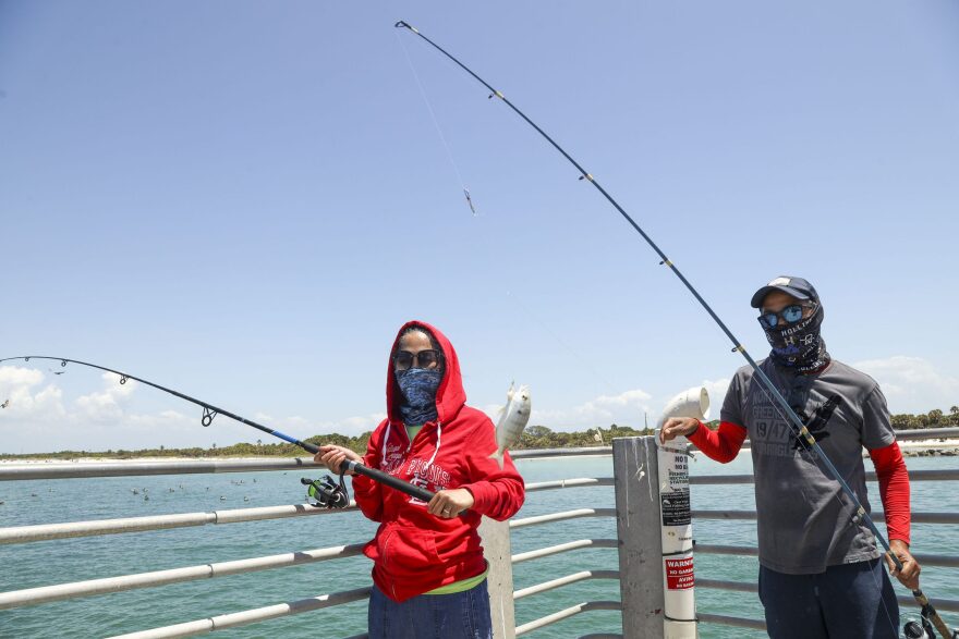 Marlie and Joebert share a smile Tuesday, April 26, at the Fort Desoto Gulf Pier. Marlie met Joebert on the water, and the two have been married for nearly 20 years.