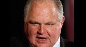 In this Jan. 13, 2009 file photo, conservative talk show host Rush Limbaugh talks with guests in the East Room of the White House in Washington. 