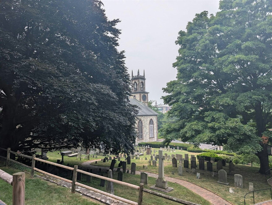 The tour visits the graveyard behind the Cathedral of St. John off of North Main Street