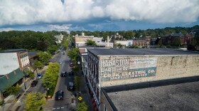 An old mural on the Coburn building in downtown Petoskey was recently repainted by artist Äbby Kent.