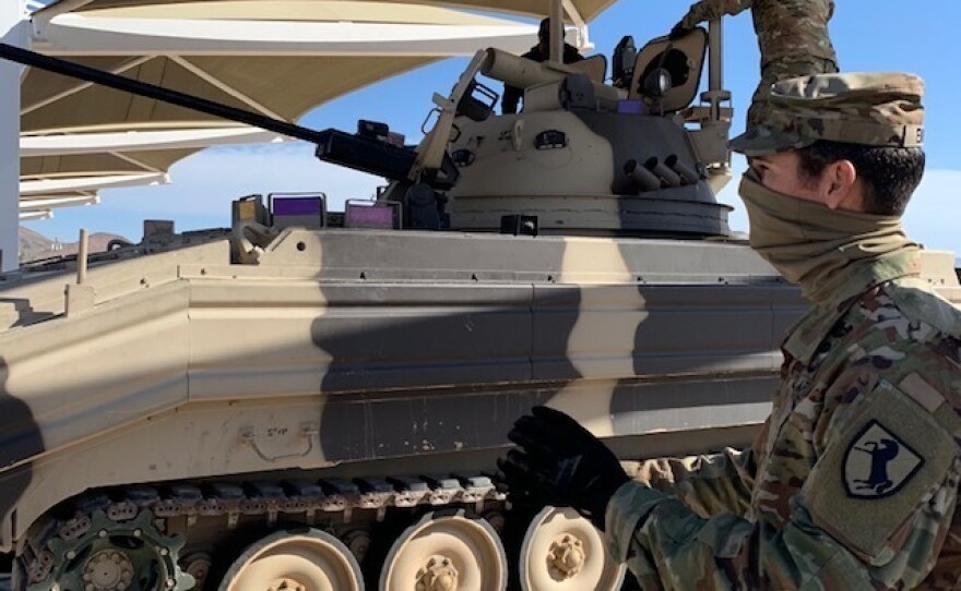 Soldiers at Fort Irwin in California wear masks to protect themselves from the coronavirus. The Army wants to get back to training thousands of troops at a time. Such training has been sidelined by the virus.