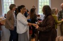 Natasha Lovelace shakes hands with a member of Forest Hill Church. 