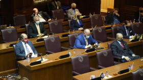 Lawmakers on the House floor for the ceremonial beginning of session were spaced out and wearing masks.