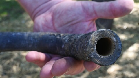 A piece of lead pipe removed from Jerry Land’s yard in Olathe shows a layer of lining inside the pipe that indicates the city’s water supply provided a thin film that prevented the pipe from leeching lead into the home’s water.