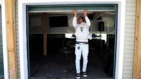 Frederick Poole closes the door of his garge that he orginaly turned into his "Man Cave" at his home on Hollenbeck St. in Rochester where he hosted parties and community gatherings in his back yard that Poole named "Da Garge".