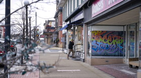 A man talks on his phone as he enters the barber shop along Main Street in Clarion, Pa., Saturday, Feb. 12, 2022. The Democratic Party's brand is so toxic in some parts of rural America that liberals are removing bumper stickers and refusing to acknowledge their party affiliation publicly.