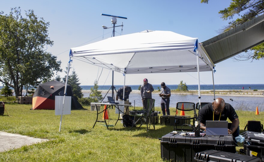 Silent Swarm officials work on the equipment on Tuesday during their testing phase of the two-week experiment.