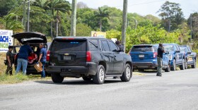 Pictured: VIPD investigates a shooting Friday afternoon along Northside Road near the Midland Road intersection in front of Moe’s Service Station. Police said responding officers found a man and woman with gunshot wounds inside the black Acura RDX. Both victims were transported to the Governor Juan F. Luis Hospital and Medical Center.