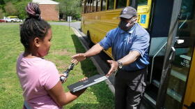A Charlotte-Mecklenburg Schools employee delivers devices to help students learn from home.