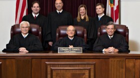 Supreme Court Justices seated for group photo.