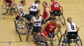 Members of the US (in red) and Canadian teams scramble for position.