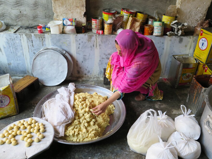Ayesha Mumtaz inspects food during a raid on a backyard sweets factory in Lahore, Pakistan. Her campaign to clean up the kitchens and food factories of Pakistan has earned her the nickname "The Fearless One."