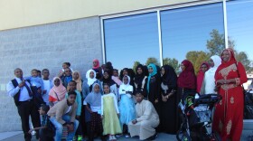 Omar Ali with his family. Omar is standing fourth form the left holding his daughter.