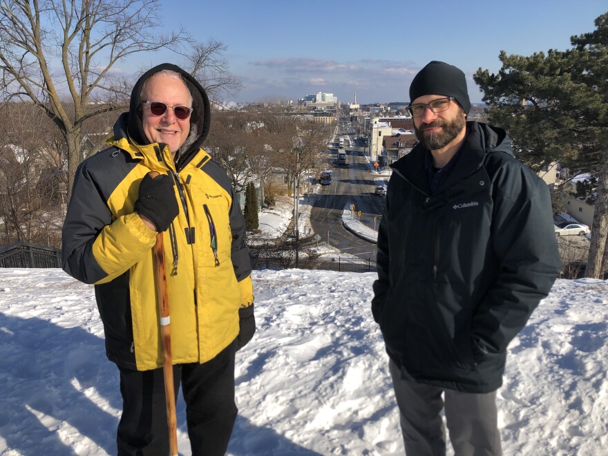 Bubbler Talk question-asker Mark Behar (left) and Milwaukee County Historical Society's Ben Barbera stand at the top of Kilbourn Reservoir Park. In the background, the North Point Water Tower is visible.