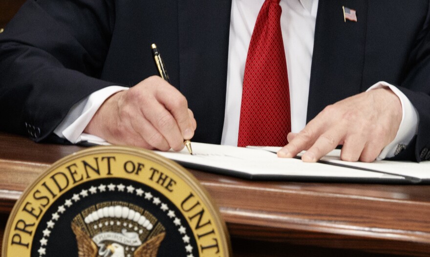 President Donald Trump signs an executive order on health care in the Roosevelt Room of the White House, Thursday, Oct. 12, 2017, in Washington. (AP Photo/Evan Vucci)