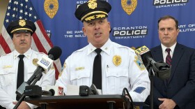 Scranton Police Chief Thomas Carroll speaks about the investigation into a Dec. 9, 2025 machete attack at the Hotel Jermyn Apartments in downtown Scranton. Listening are, at left, Scranton Police Captain Dennis Lukasewicz, and at right, Lackawanna County District Attorney Brian Gallagher. 'Callers reported screams, visible blood, with one caller identifying herself as a victim,' the chief said. 'Many patrol officers arrived very quickly.'