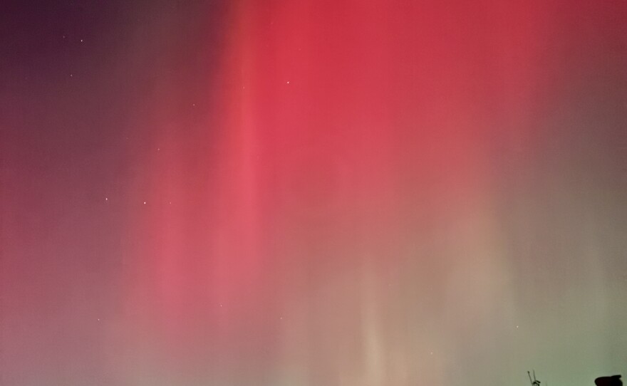 A colorful display of the aurora borealis over Sioux Falls at 8:30 p.m. on Nov. 11, 2025. The northern lights range from deep hues of red to vibrant green.