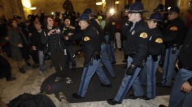 Washington State Patrol troopers use tasers to control a crowd of protestors who rushed at the locked doors of the Capitol and attempted to let people inside after the building was closed, in Olympia, Wash., on Monday.