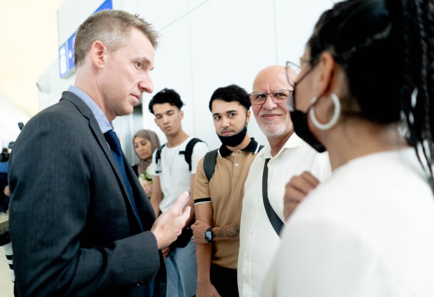 Jason Kander, former Secretary of State of Missouri and a one of the founders of the Afghan Rescue Project, speaks to Moji Sidiqi, who manages the Afghan Support Program, alongside the Azimi family, who arrived in St. Louis after fleeing Afghanistan