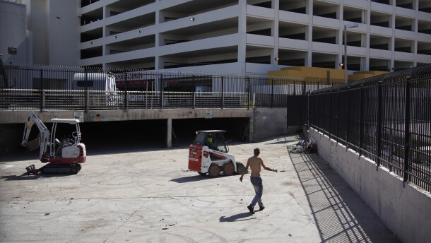 A homeless man watches as workers clear a homeless encampment in a storm drain near a casino in Las Vegas on Thursday, May 26, 2022. Hundreds of homeless people die in the streets each year from the heat, in cities around the U.S. and the world. The ranks of homeless have swelled after the pandemic and temperatures fueled by climate change soar. (AP Photo/John Locher)