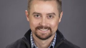 A professional headshot for Brian Duggan. He is looking toward the camera and smiling.