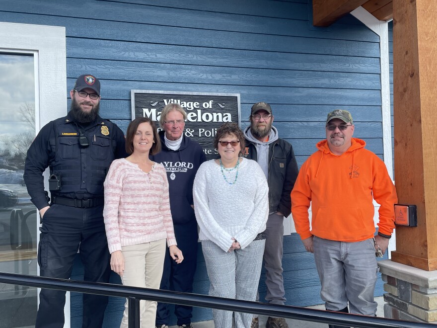 Some of Mancelona's Village Hall staff, village president Mike Allison is center, residents and public works employees Jamie Fisher and Craig Hart to the end on right.

Photo CreditL: Tyler Thompson