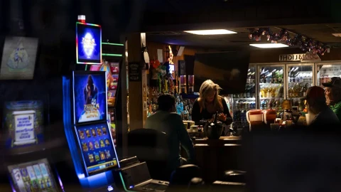 Slot machines light up the front window of a bar in Golconda, Illinois.