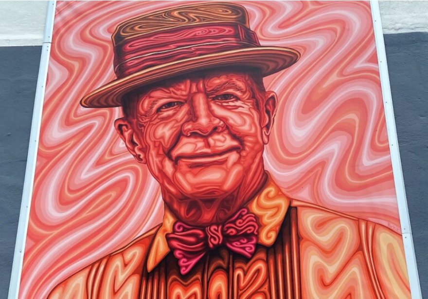 Large-scale reproduction of a Mike Casey portrait by artist Alex Rubio on the facade of Contemporary at Blue Star