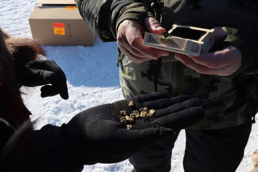 gold in a person's gloved hand