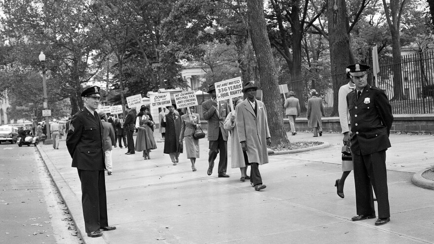 Officers stand by in 1955 as religious leaders from Chicago demonstrate outside the White House in Washington over the murder of 14-year-old Emmett Till.