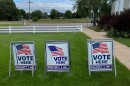 Three signs reading "vote here" show the way to three of Blair Township's voting precincts.