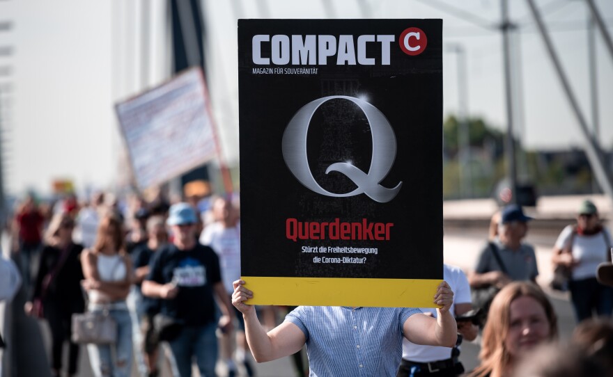 A demonstrator holds a sign saying Querdenker ("lateral thinker") during a protest against Germany's coronavirus measures in Düsseldorf in September. The embrace by some AfD members of the Querdenker movement — a loose grouping of libertarians, vaccination opponents and conspiracy theorists — has cost the party support.