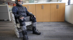 Corgan’s Mike Steiner sits in the age suit, which both weighs you down and limits your mobility and sensitivity to the world around you. (Robin Lubbock/WBUR)