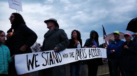 Dozens of Connecticut residents converge along a bridge at a vigil and rally for the environment and against President Trump's recent decision to withdraw the United States from the Paris climate accord on June 4, 2017 in Westport, Connecticut. (Spencer Platt/Getty Images)