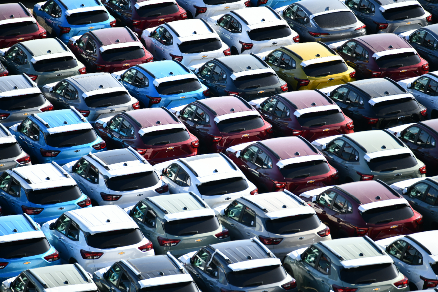 Rows of new cars packed tightly together with no space to move any of them.