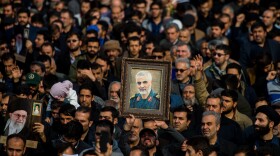 The U.S. killed Iranian Maj. Gen. Qassem Soleimani in a targeted drone strike in Baghdad. A U.N. investigator says the action violated Iraq's sovereignty. Here, protesters in Tehran, Iran, hold up an image of Soleimani during a demonstration on Jan. 3.