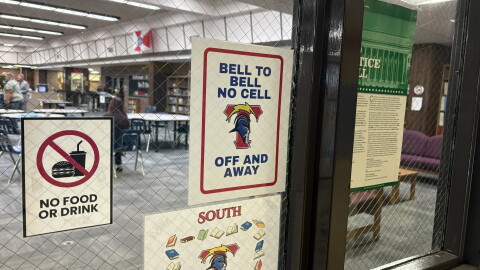 A sign posted on the door of the library at Wichita South High School advises students not to use their phones. In the spring, Kansas lawmakers banned student cell phone use at K-12 schools in the state. 