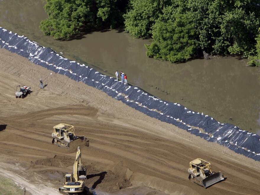 Crews push extra sand onto Mississippi River levees in the Sny drainage district in Illinois during a flood in June 2008.