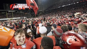 Cincinnati fans and players celebrate after winning the American Athletic Conference championship NCAA college football game against Houston Saturday, Dec. 4, 2021, in Cincinnati.