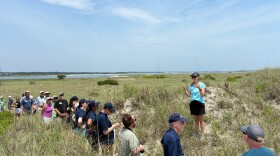 Elizabeth Pennix, the Southern Sites Manager for Masonboro Island, gives a tour of the island to the NCDEQ Secretary and other guests.