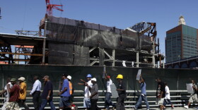 A coalition of contractors and construction laborers march and rally outside the Barclays Center construction site to protest Bruce Ratner's Atlantic Yards development in Brooklyn, New York on Wednesday, July 27, 2011. Organizers say Ratner's promise of contracts and jobs for community residents have not been kept.
