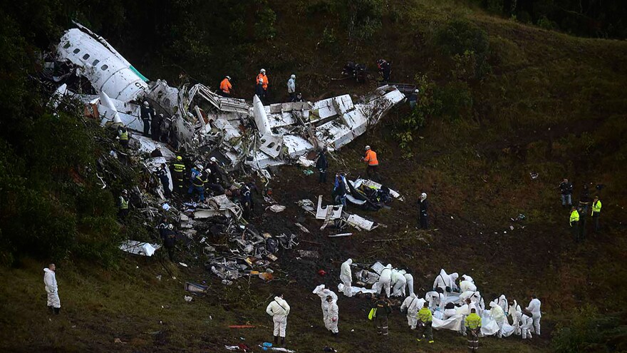 Rescuers search for survivors from the wreckage of the LAMIA airlines charter plane carrying members of the Chapecoense Real football team. The plane crashed in the mountains in Colombia late Monday, killing scores of people and leaving only a handful of survivors, officials said.