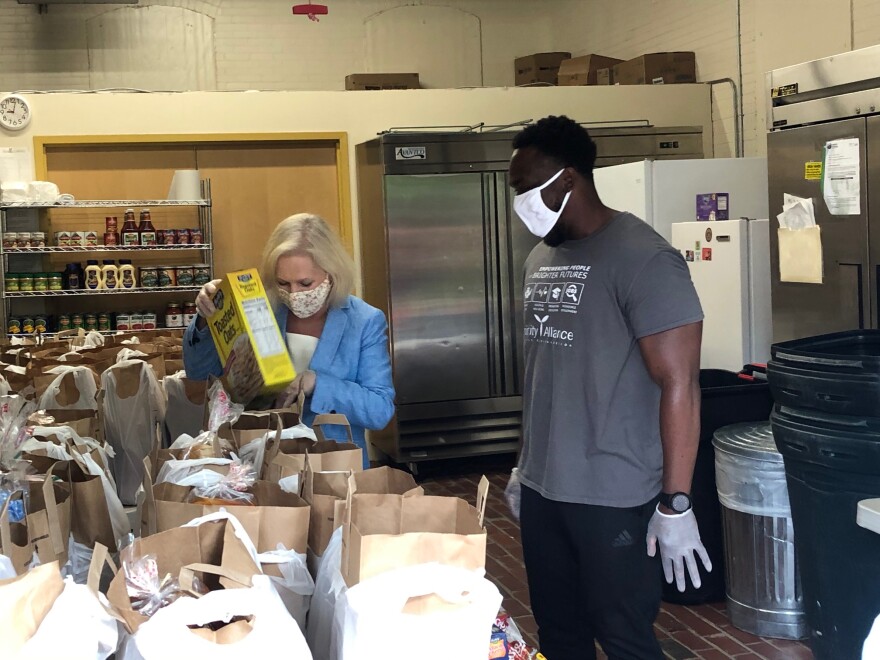 Senator Kirsten Gillibrand with Trinity Alliance of the Capital Region’s Arbor Hill Food Pantry Manager Andre Lewis