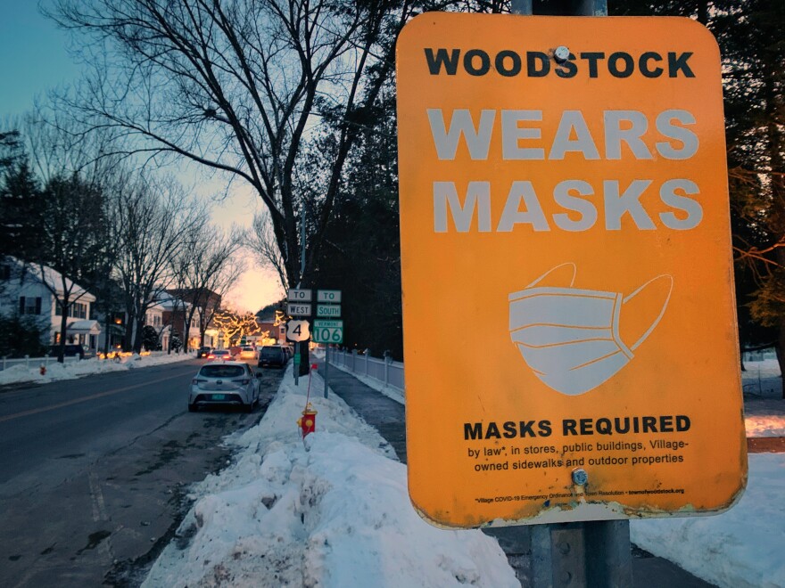 A yellow sign reminds Woodstock residents and visitors to wear masks.