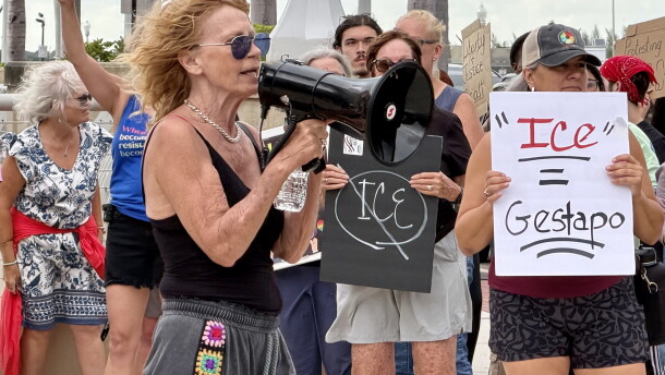 Legal observer June Sanson speaks to a crowd of approximately 150 people during the Ice Out Now protest in front of the Luminary Hotel in downtown Fort Myers in a effort to shine light on how ICE agents are staying in hotels to preform ICE activities throughout the community.