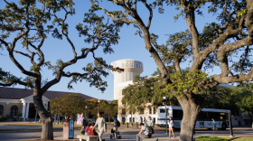 Students wait at a bus stop on the Texas A&M University campus in College Station, on Nov. 12, 2025.