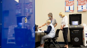 Connie Ford, back, assists Ann Massey, left, and Linda Frageman at a training lab at the Collin County Elections Department.