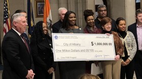 James presented the mayor and city officials with an oversized check. 