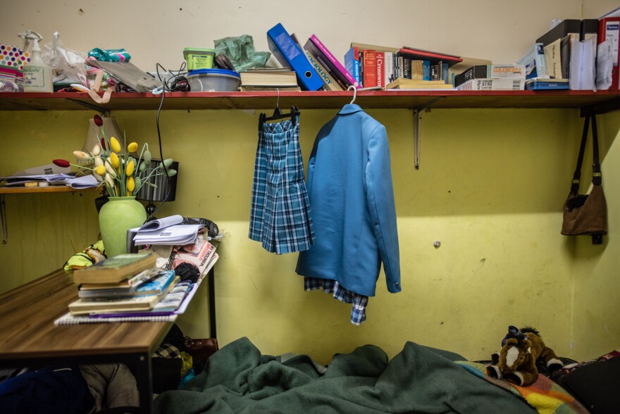 School clothes belonging to 14-year-old Akisha Arendse hang on a shelf in the room she shares with her father in Cissie Gool House.